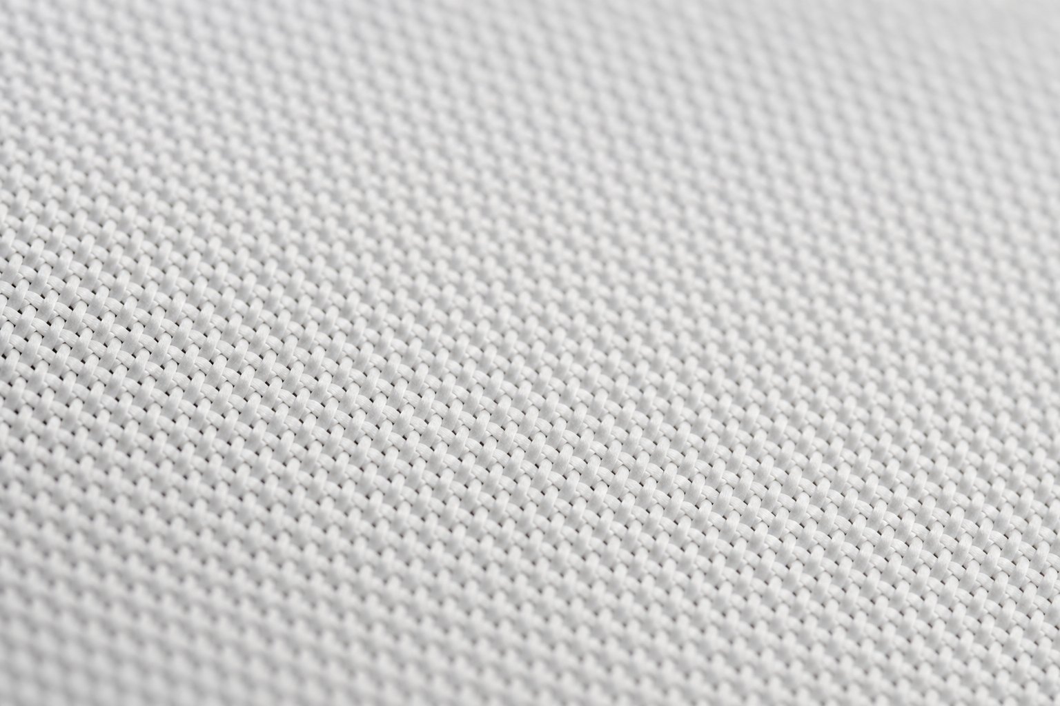 Close-up of woven acoustically transparent screen fabric showing the fine weave openings