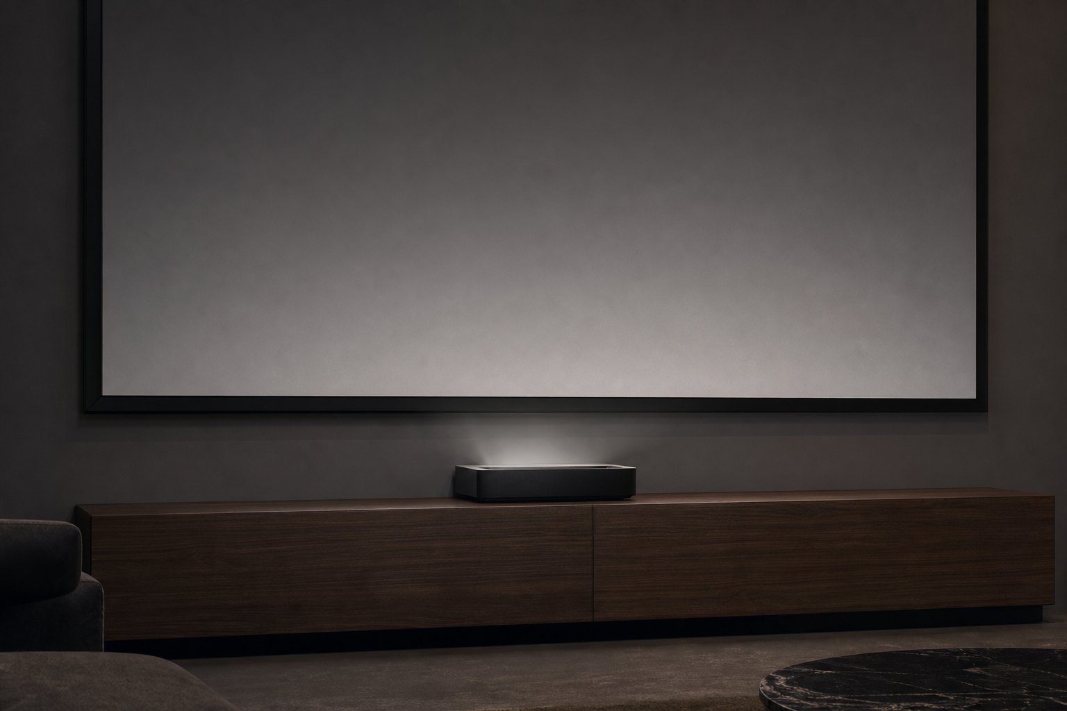 Ultra-short-throw projector on a low cabinet directly beneath a wall-mounted projection screen